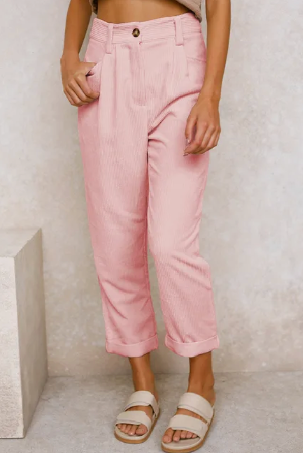 Relaxed corduroy pants in pink with button front, side pockets, and cuffed ankle hem