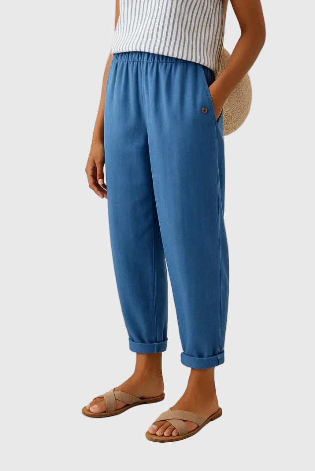 Blue relaxed pants with elastic waistband, button detail, and cuffed hems
