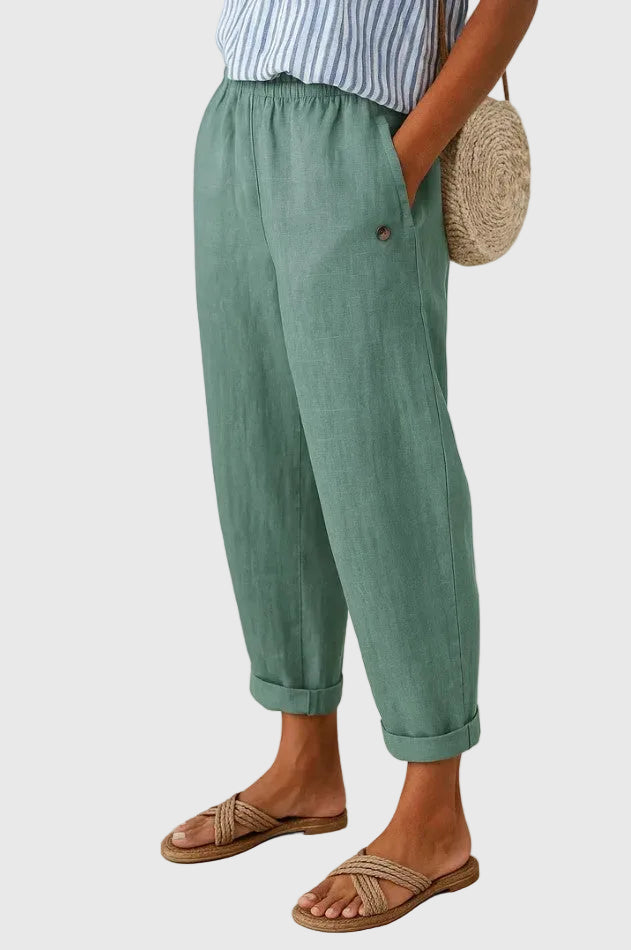 Turquoise relaxed pants with elastic waistband, button detail, and cuffed hems