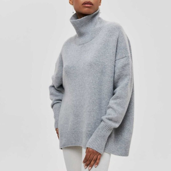 Heather gray turtleneck knit sweater with ribbed collar and cuffs.