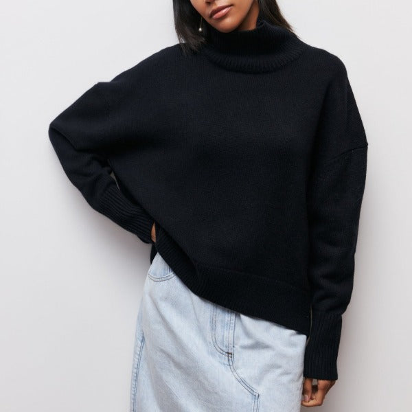 Black turtleneck knit sweater with ribbed collar and wide cuffed sleeves.