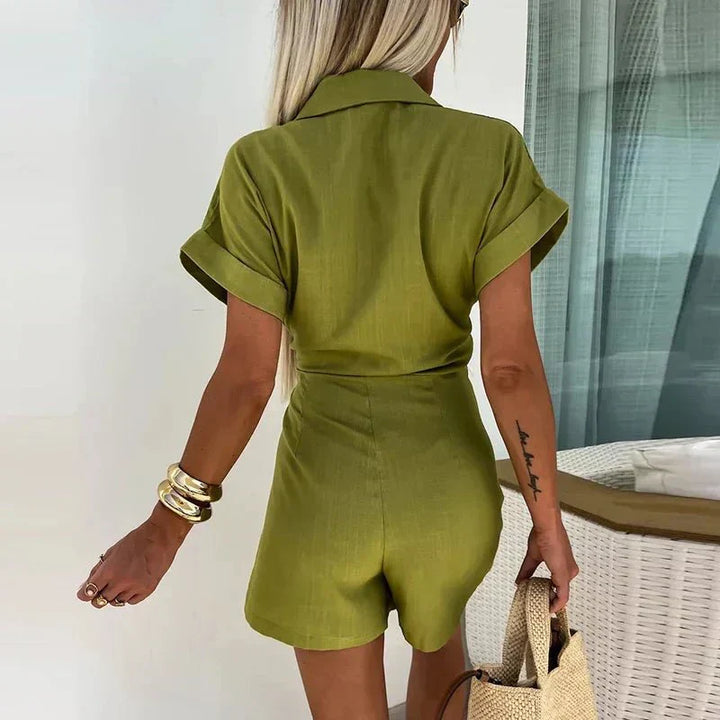 Back view of olive green wrap playsuit with short sleeves and tied waist.
