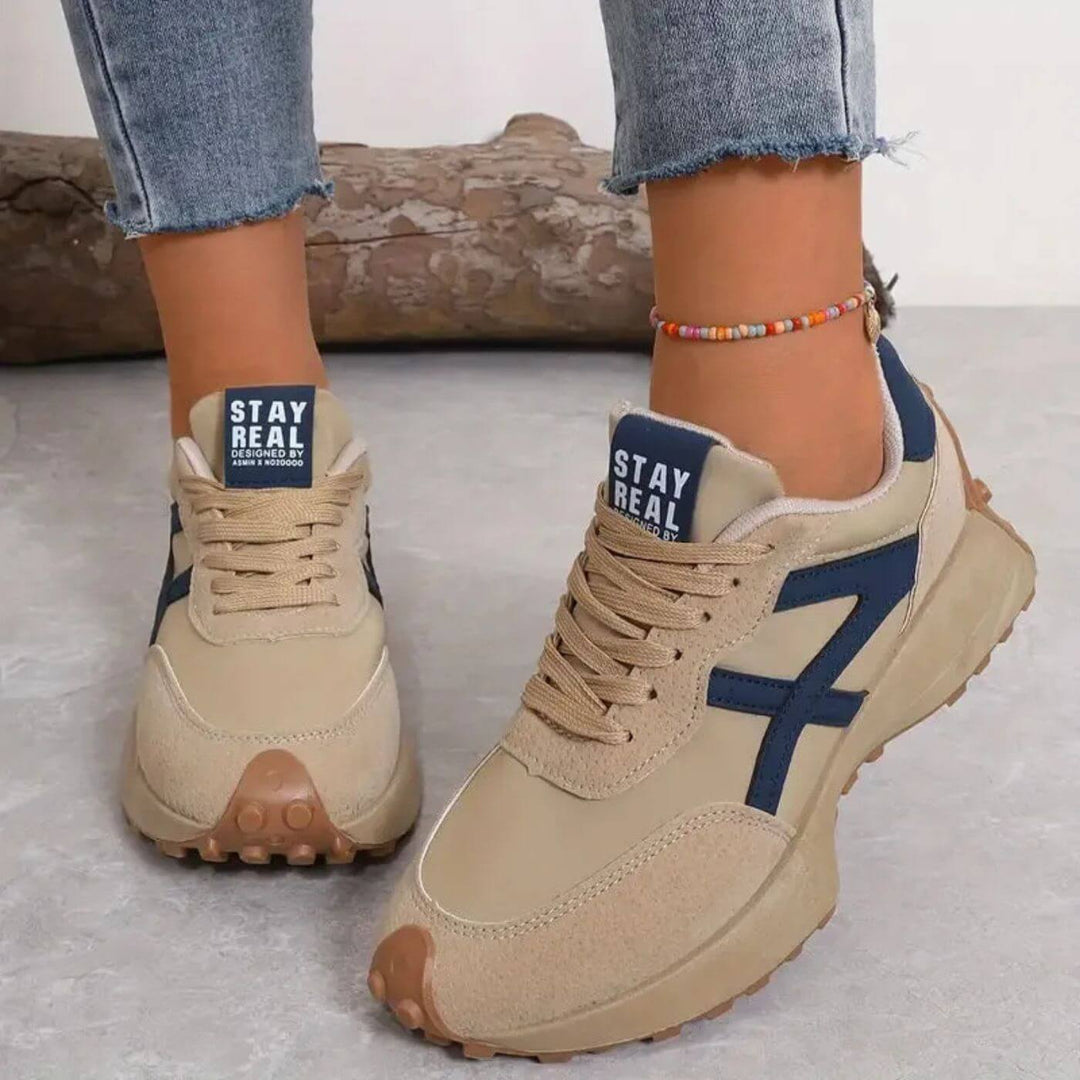 Beige lace-up trainers with blue side panels and chunky rubber sole, 'STAY REAL' tab