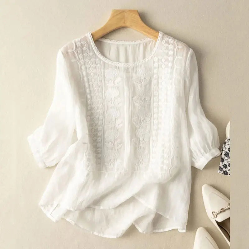 White embroidered blouse with vertical panel embroidery and elbow-length puff sleeves