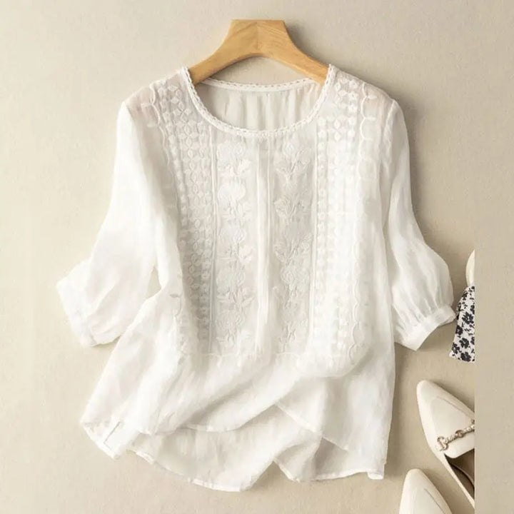 White embroidered blouse with vertical panel embroidery and elbow-length puff sleeves