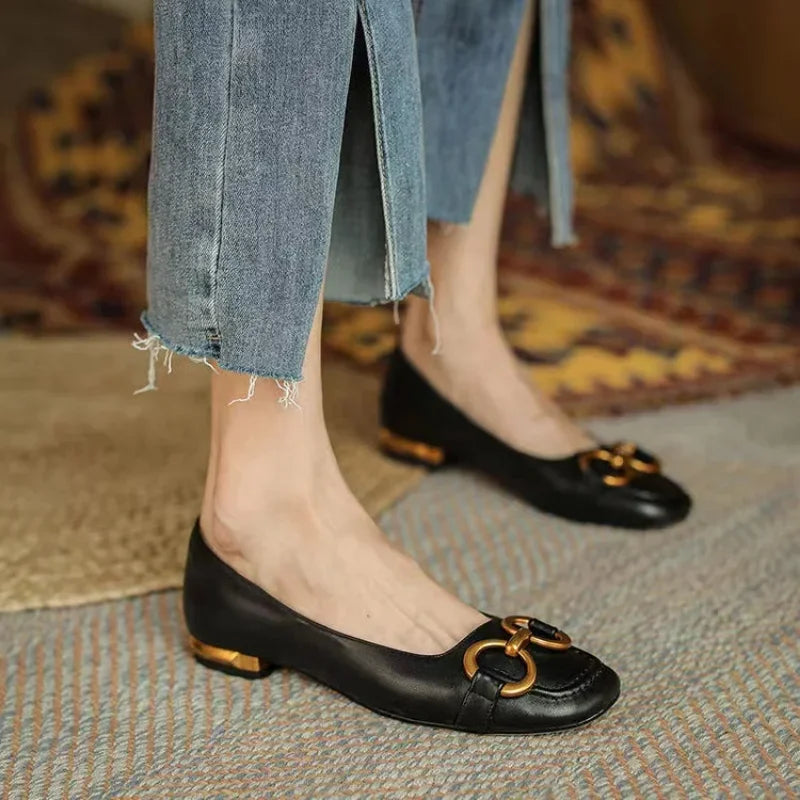 Black ballet flats with gold chain-link ornament and low block heel