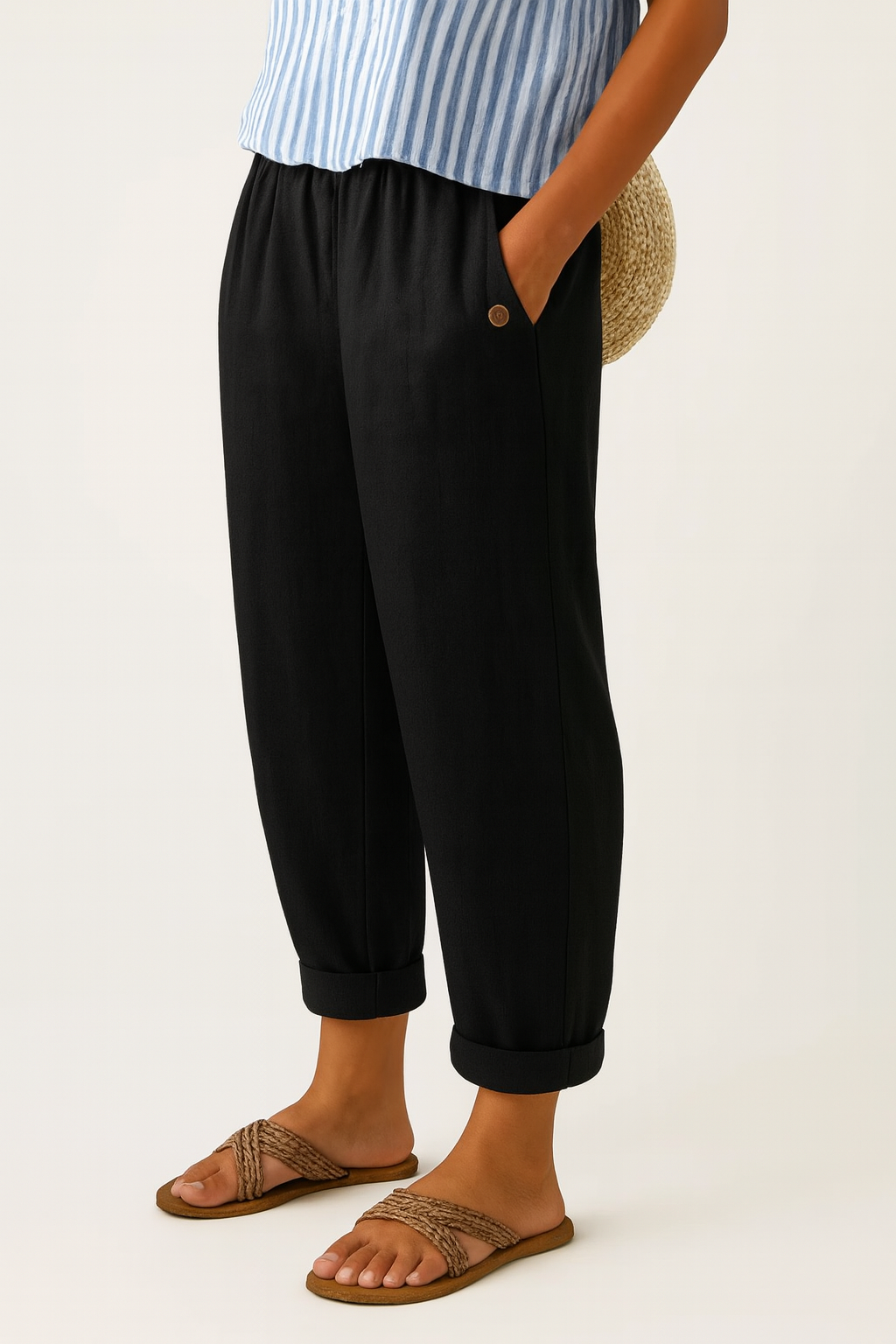 Black relaxed pants with elastic waistband, button detail, and cuffed hems