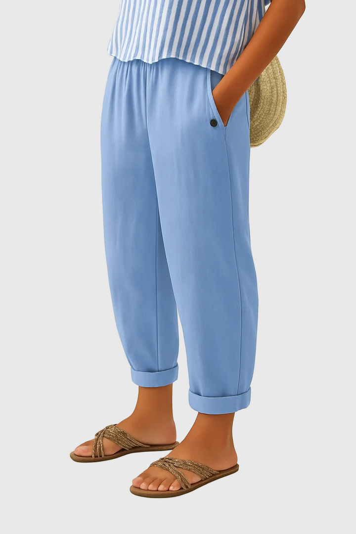 Light blue relaxed pants with elastic waistband, button detail, and cuffed hems