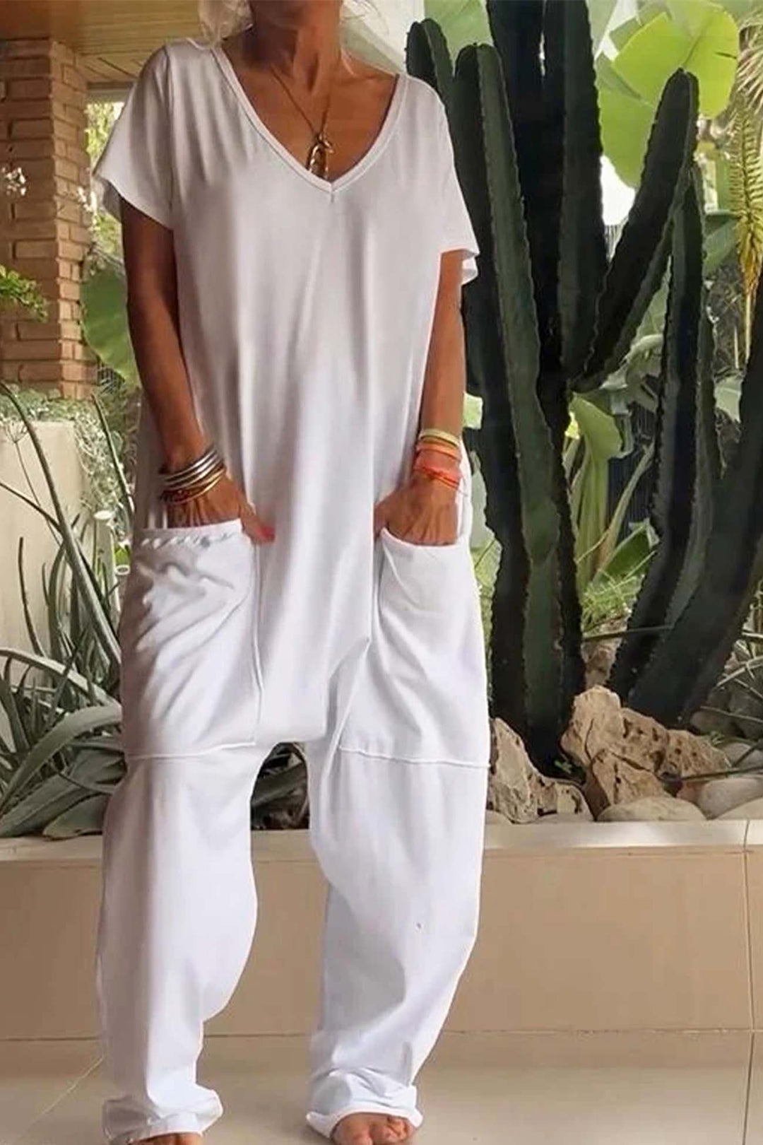 White relaxed pocket jumpsuit with V-neck, short sleeves, and front patch pockets