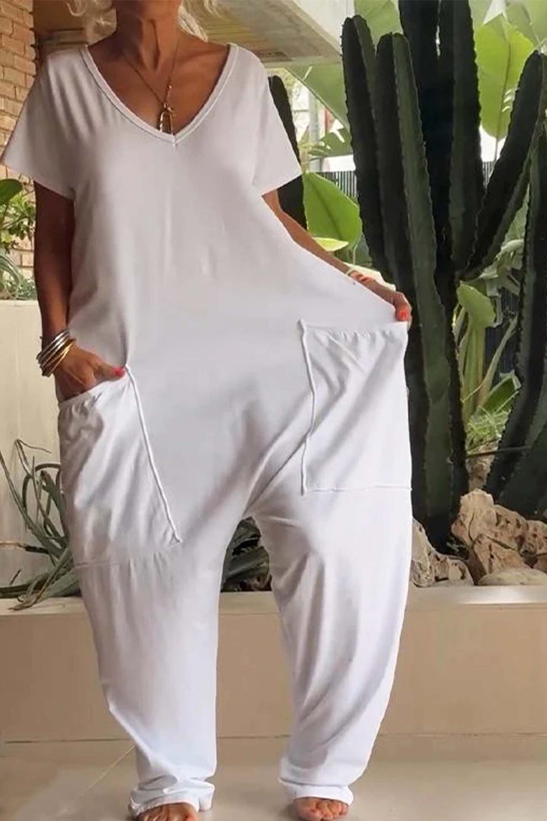 White relaxed pocket jumpsuit detail, V-neck, short sleeves, and front patch pockets