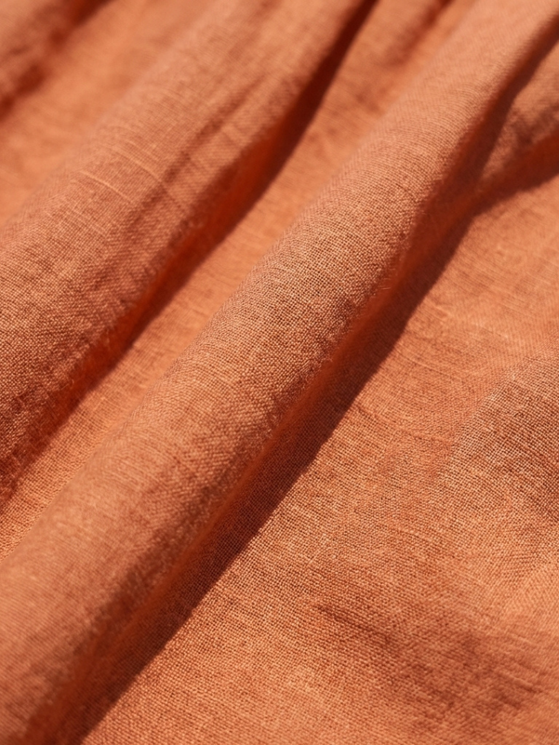 Orange textured fabric with stitched tier seam lines