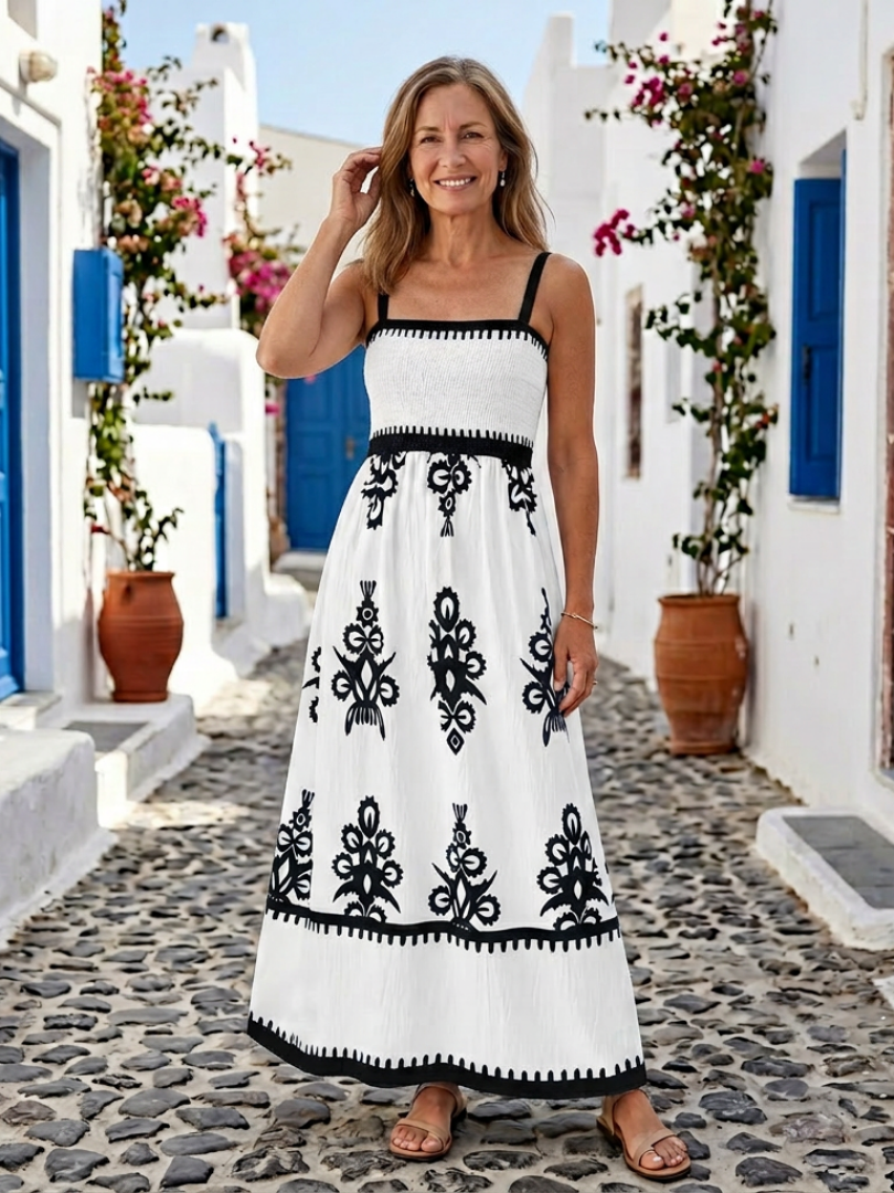 Sleeveless smocked bodice maxi dress with white base and black floral print