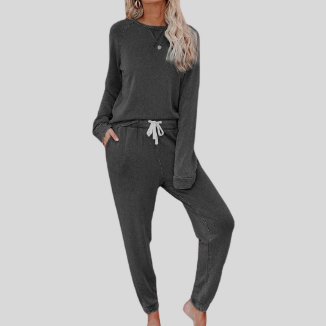 Dark gray cozy lounge set: crewneck long-sleeve top and jogger pants with drawstring.