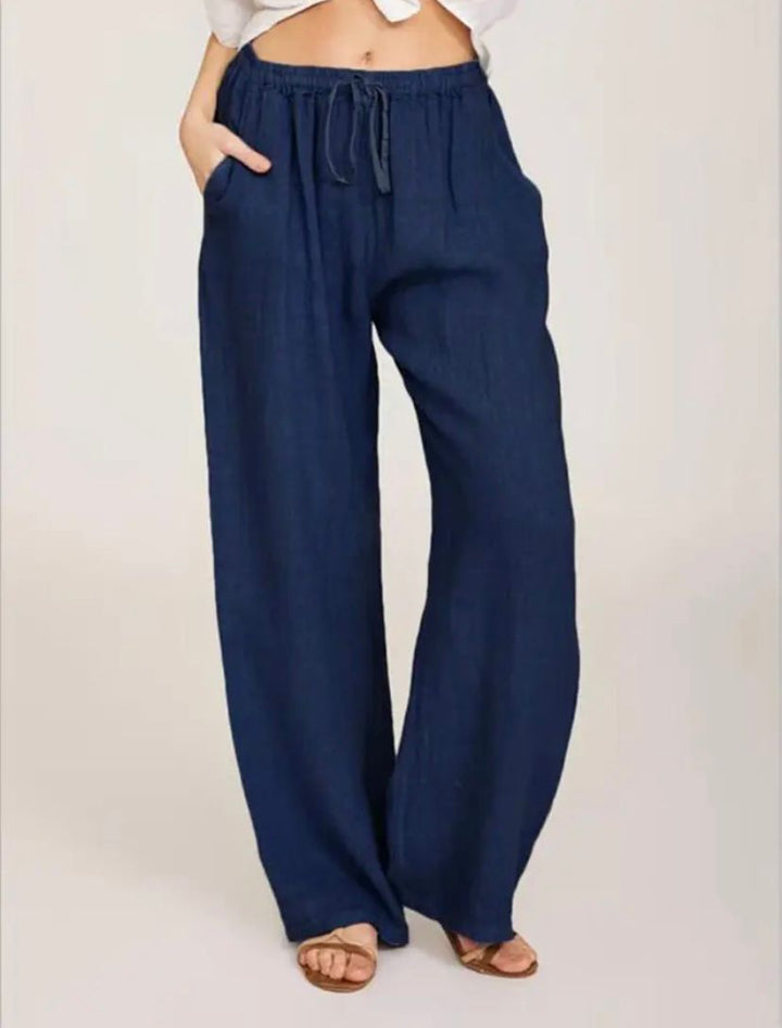 Navy drawstring pants, elastic waist, loose wide-leg silhouette.