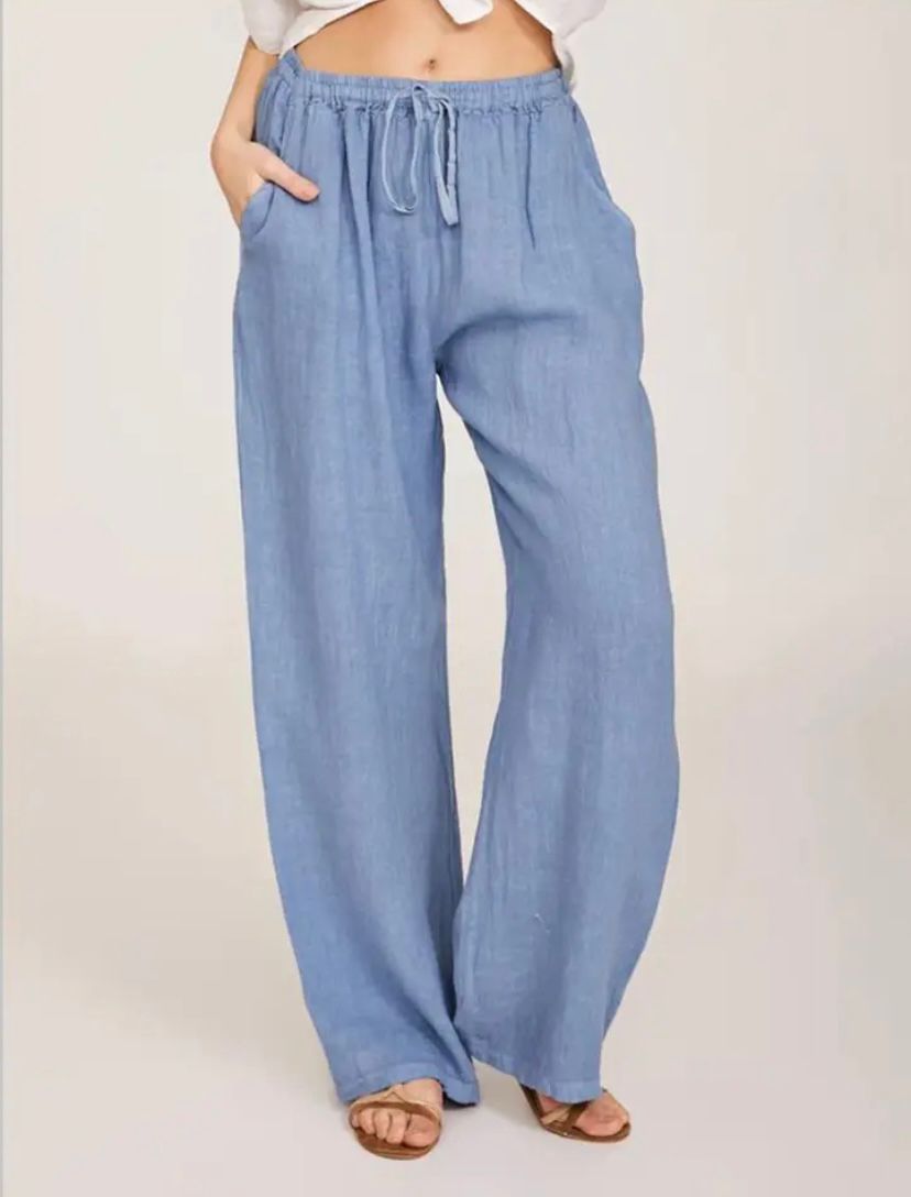 Light blue drawstring pants with elastic waistband and relaxed wide legs.