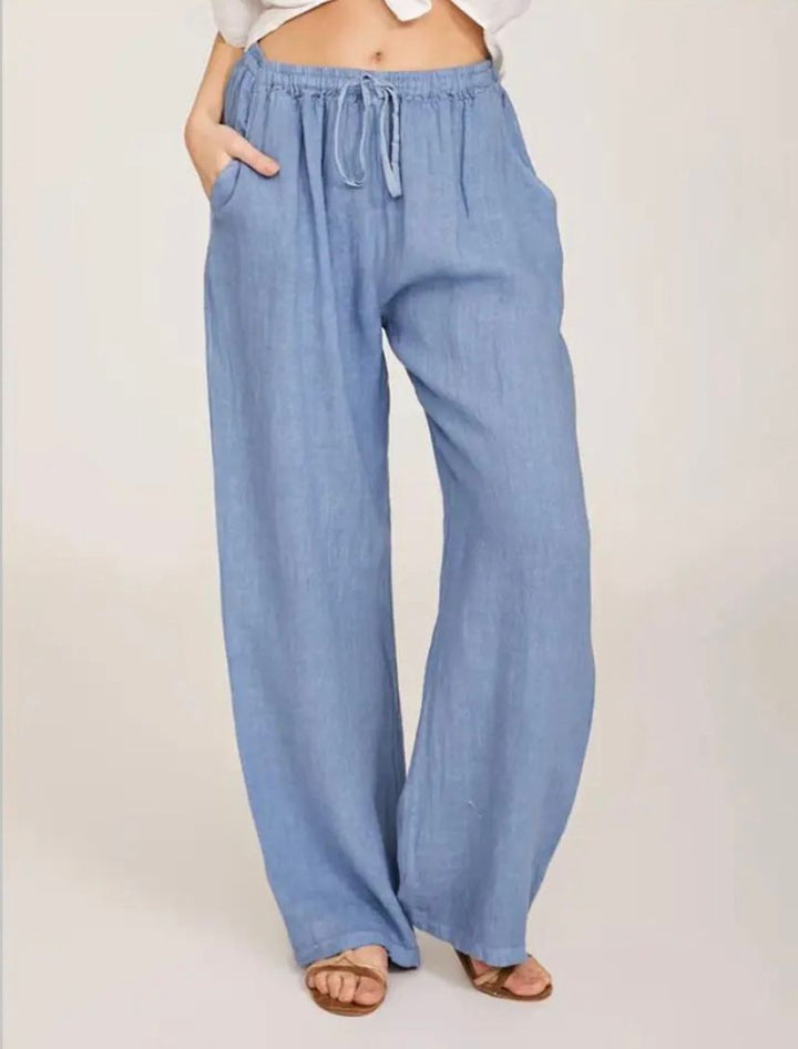 Light blue drawstring pants with elastic waistband and relaxed wide legs.