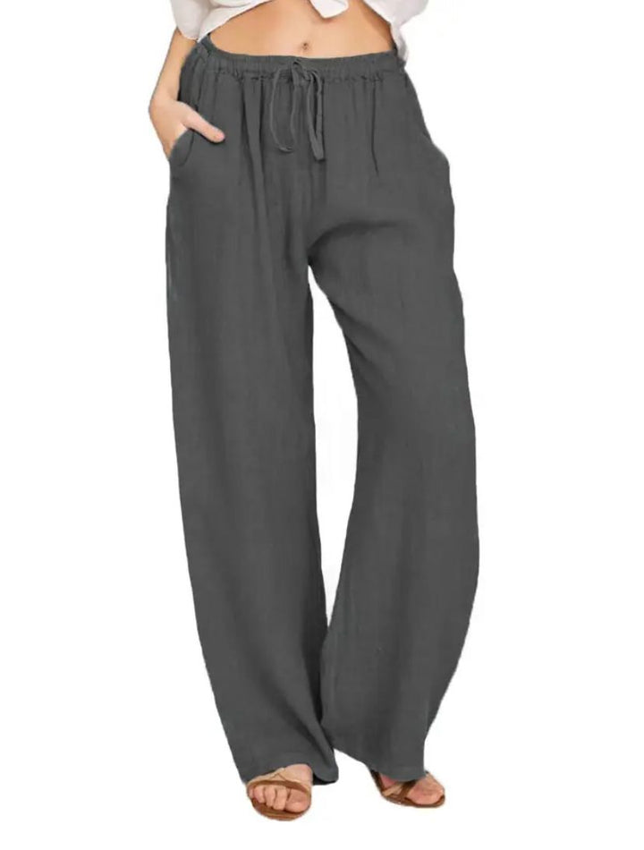 Dark gray drawstring pants with elastic waist and relaxed wide-leg fit.