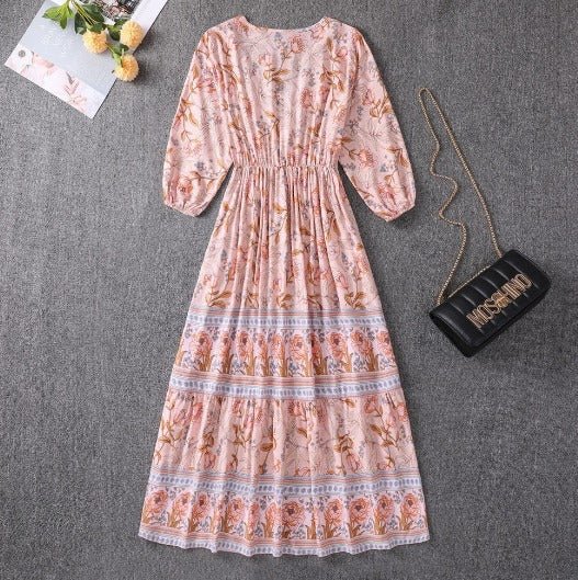 Peach floral boho midi dress with buttoned V-neck, long sleeves, tiered hem