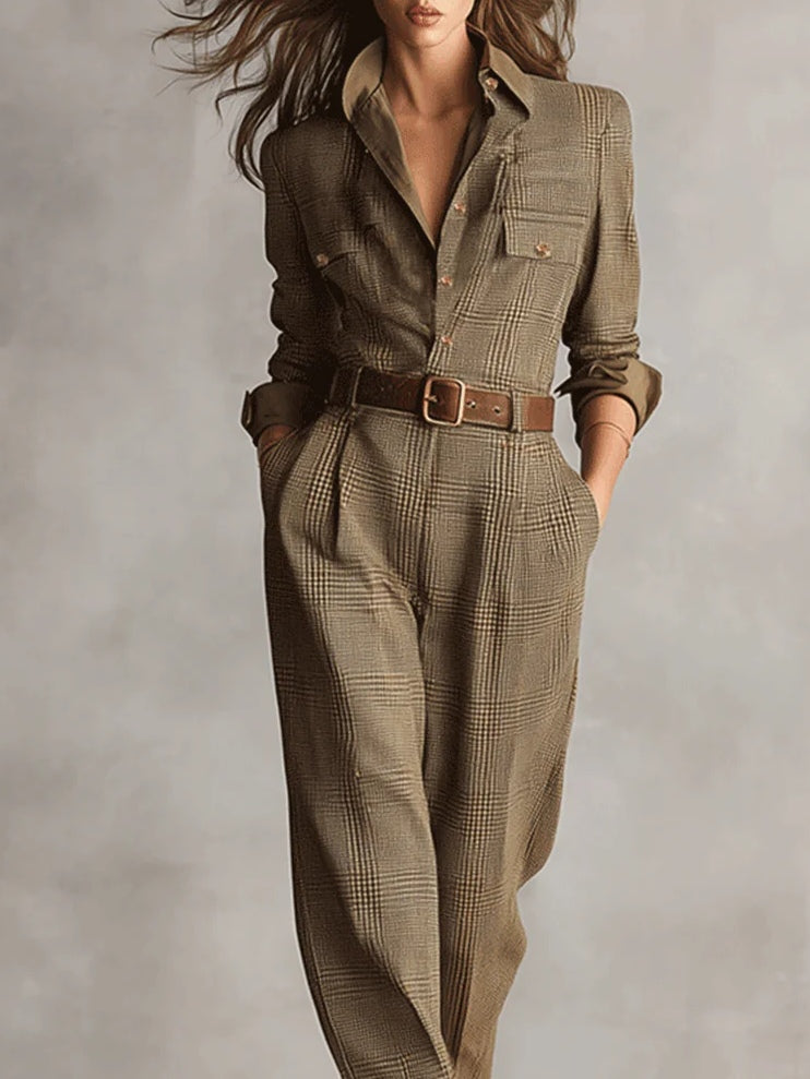Belted plaid jumpsuit with collared V neckline, long sleeves, and waist belt