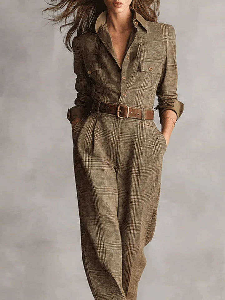 Belted plaid jumpsuit with collared V neckline, long sleeves, and waist belt