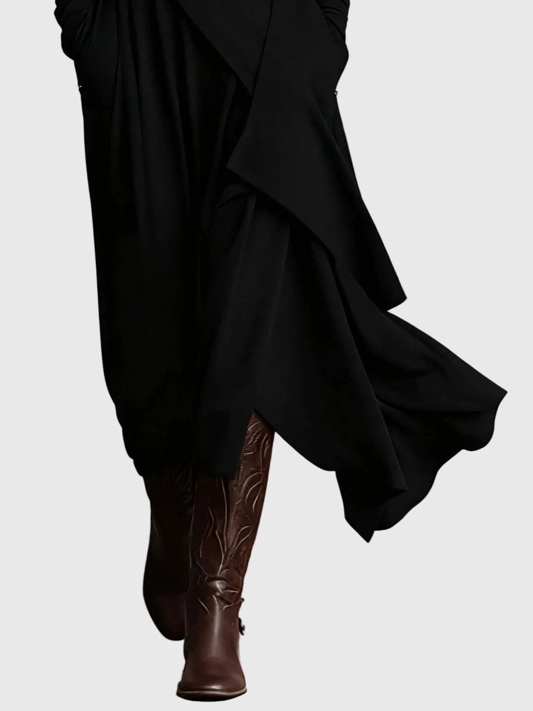 Black draped maxi dress with layered skirt panels and asymmetric hem detail