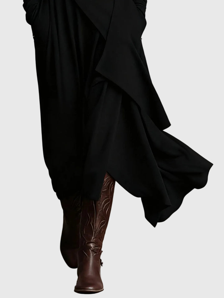 Black draped maxi dress with layered skirt panels and asymmetric hem detail
