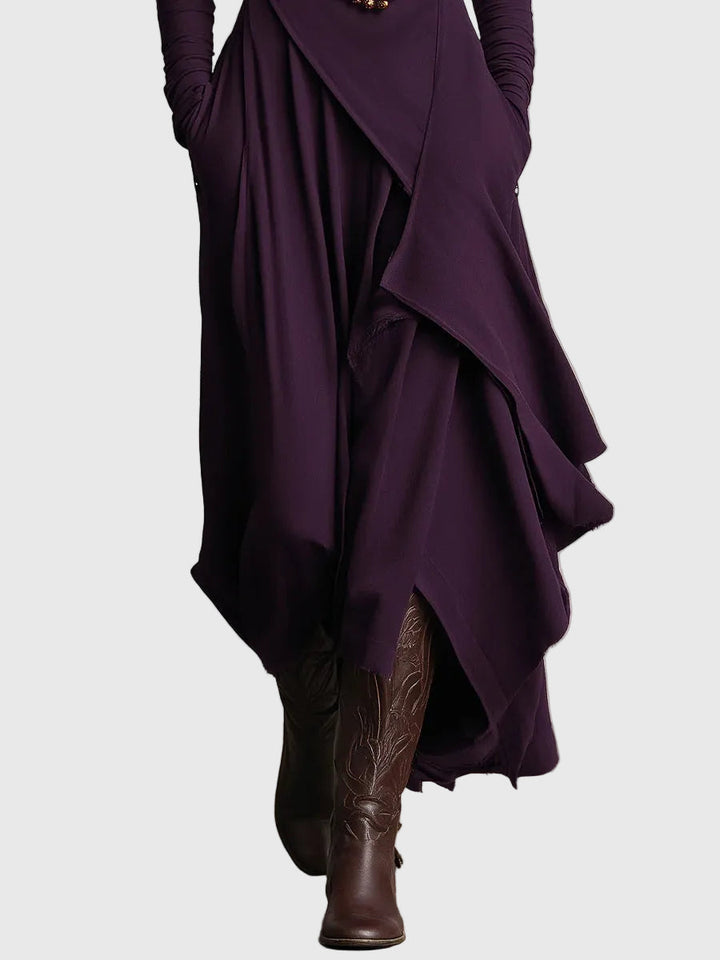 Purple draped maxi dress with layered skirt panels and asymmetric hem detail