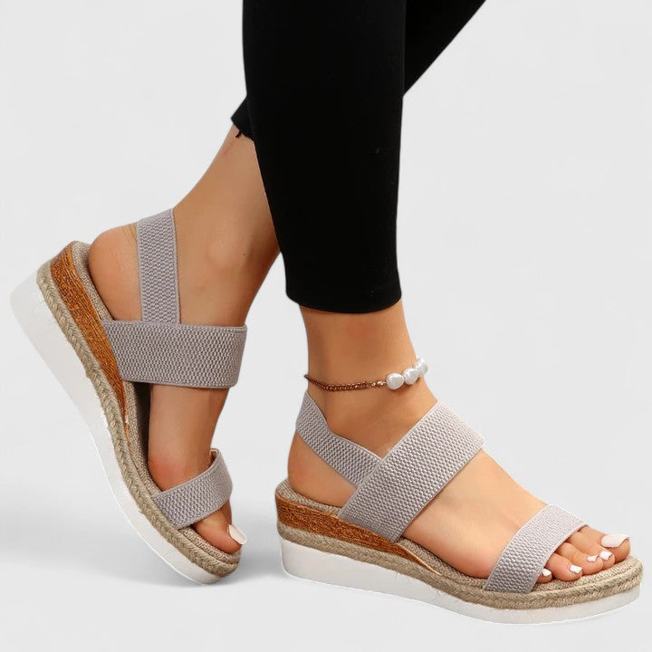 Grey women's orthopedic sandals with two wide adjustable straps and cushioned sole.
