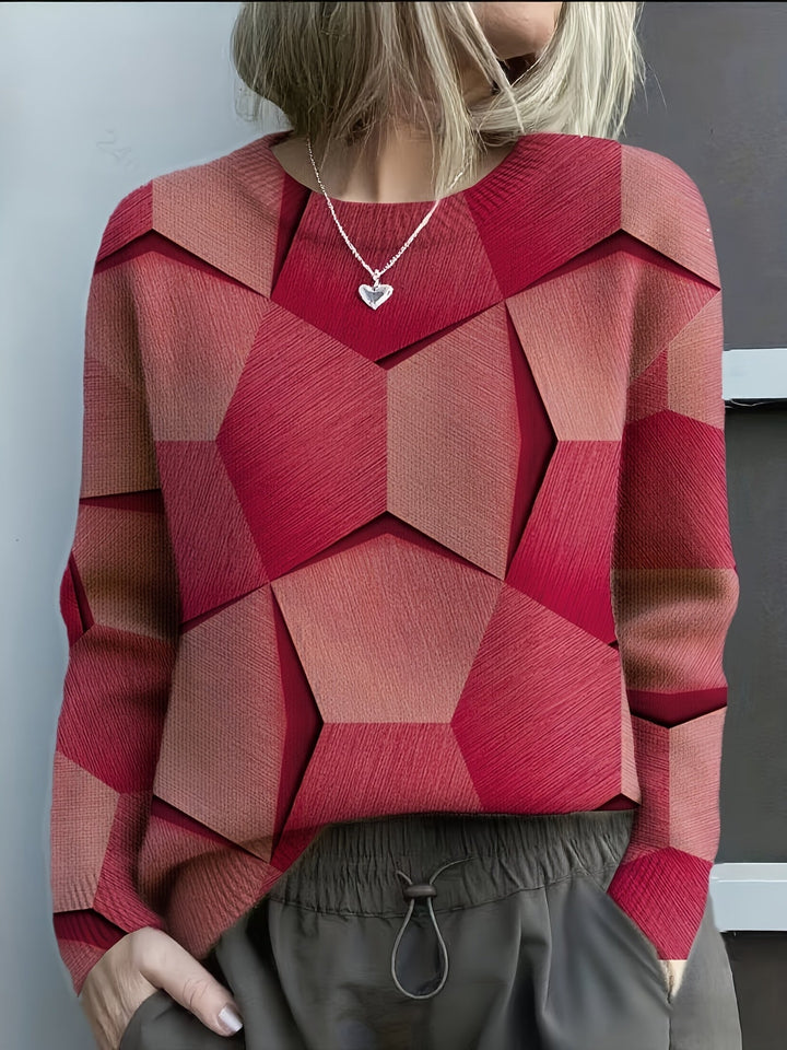Red and blush geometric knit sweater with wide V-neck and long sleeves