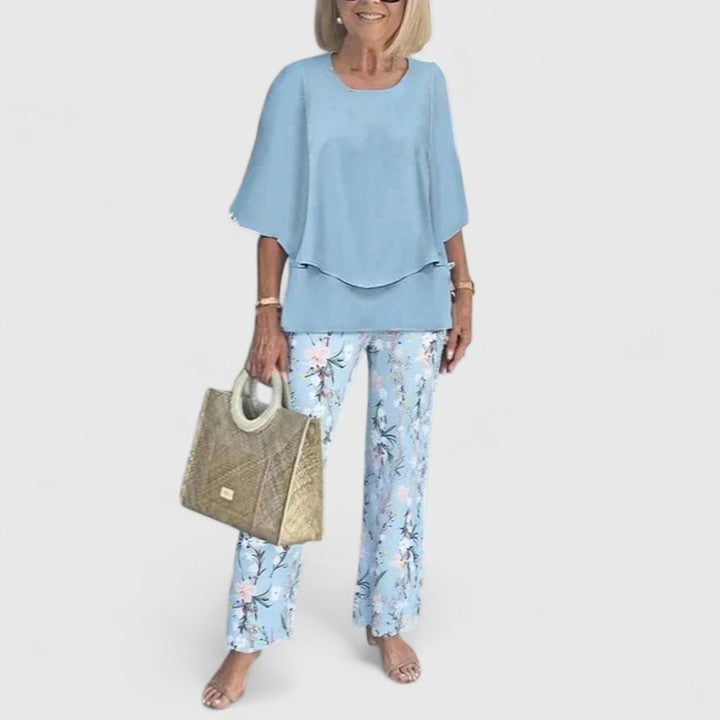 Two-piece blouse and trouser set with light blue blouse and floral-print trousers