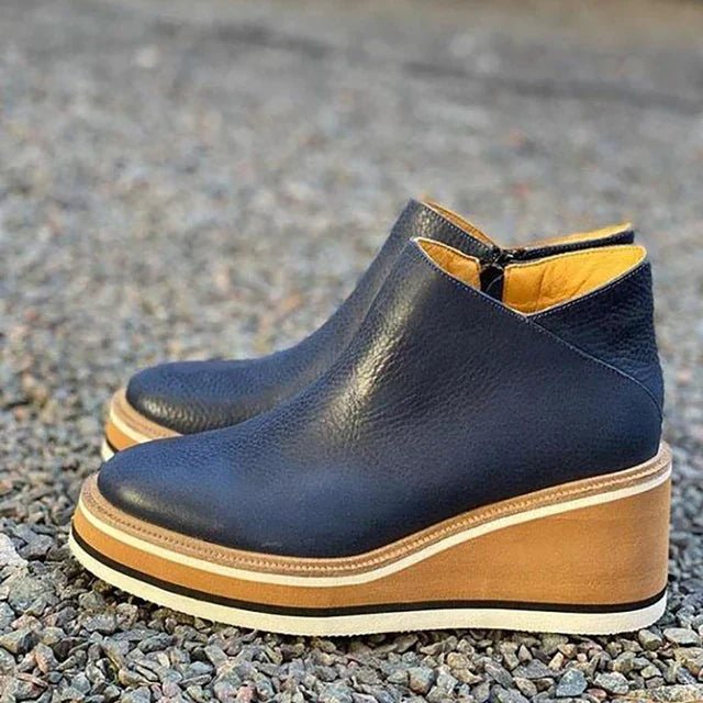 Platform slip-on boots in navy-blue leather with side gore and tan-striped platform sole