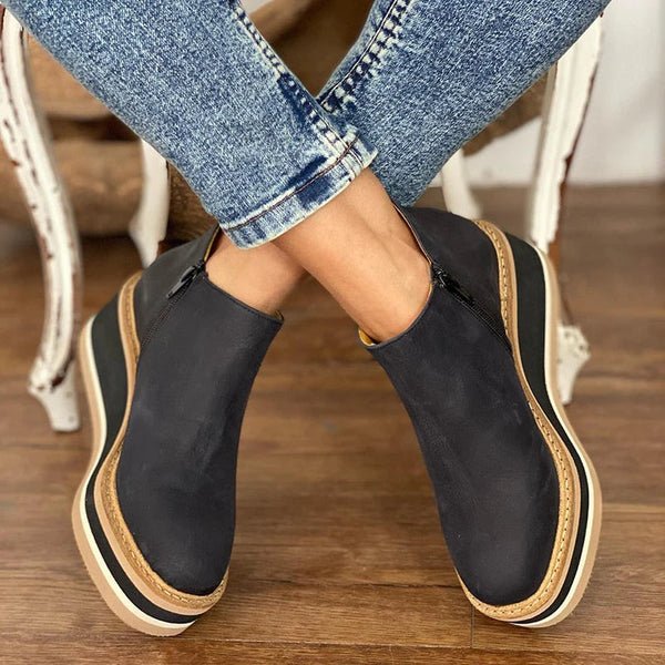 Platform slip-on boots in black leather with side gore and striped platform sole