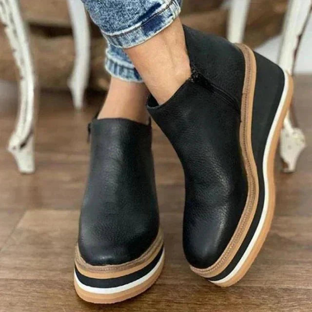 Platform slip-on boots in black leather with side gore and white-striped platform sole