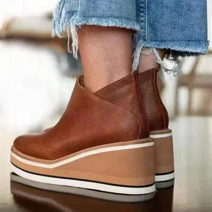 Platform slip-on boots in rust-brown leather with side gore and striped platform sole