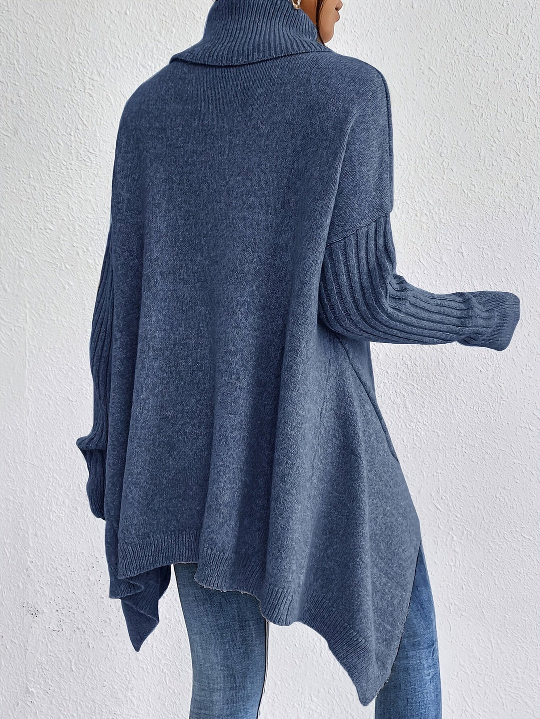 Sea blue oversized turtleneck sweater shown from back, ribbed cuffs and high-low hem