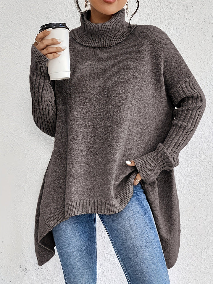 Dark gray oversized turtleneck sweater with ribbed sleeves and cuffs, relaxed fit.