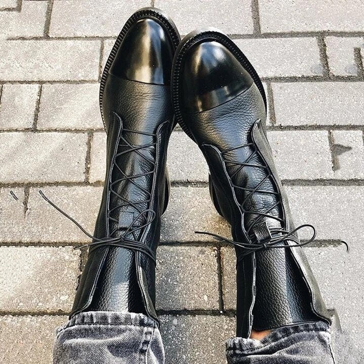 Black lace-up ankle boots, front view with round toe and crisscross laces.