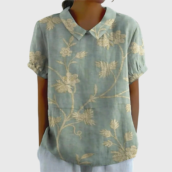 Floral collar blouse in light blue with gold-tone botanical print, short sleeves