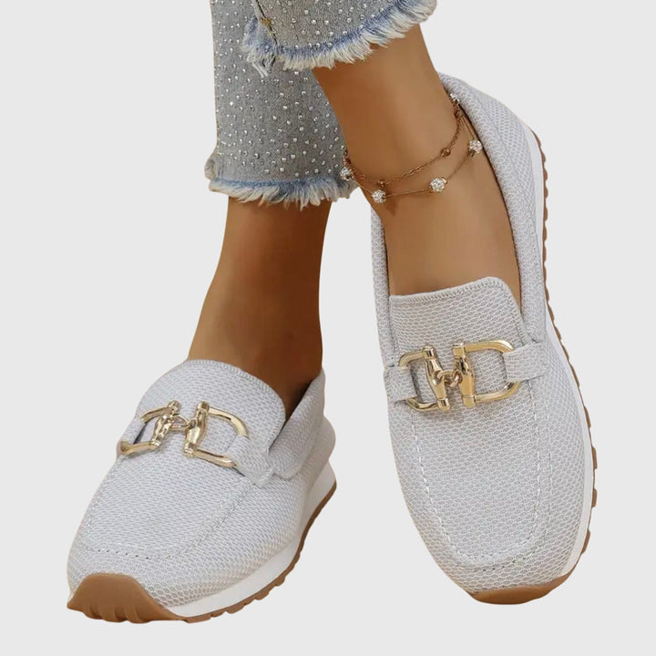 White chain-detail slip-on loafers with gold buckle detail on textured upper