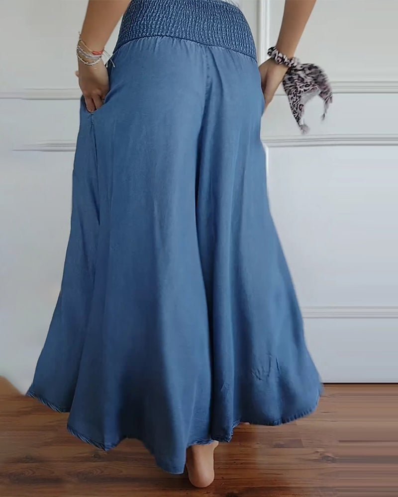 Blue wide-leg pants, back view with elastic smocked waist and billowy hem