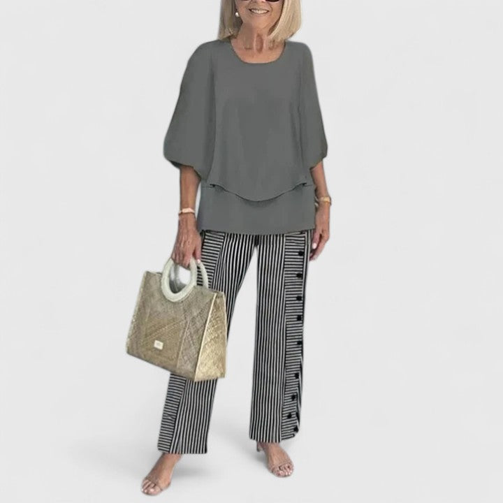 Two-piece blouse and trouser set with charcoal blouse and black-and-white striped trousers