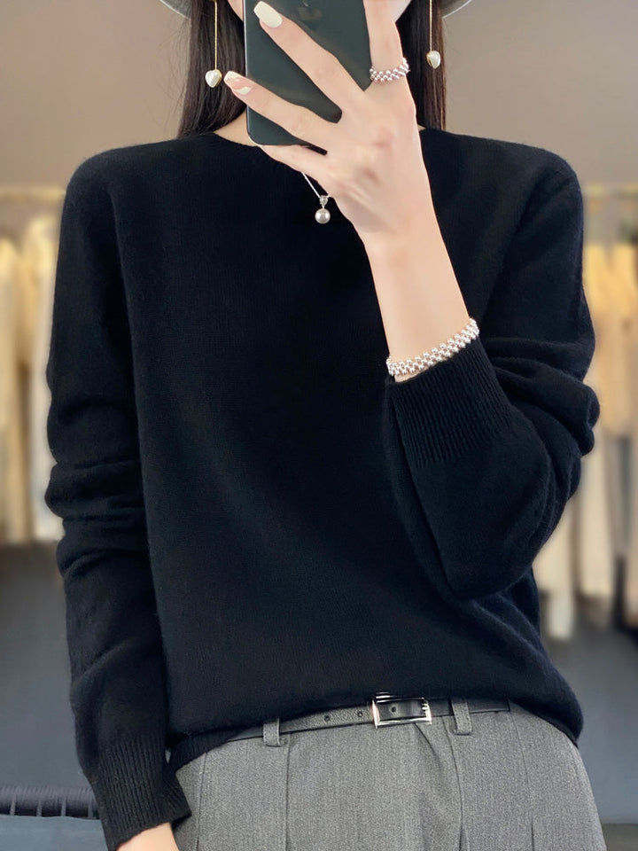 Soft knit pullover sweater in black with buttoned round neckline and long sleeves