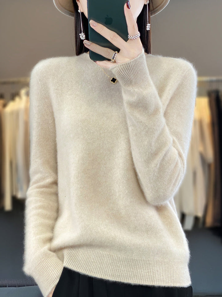 Soft knit pullover sweater in cream with buttoned round neckline and long sleeves