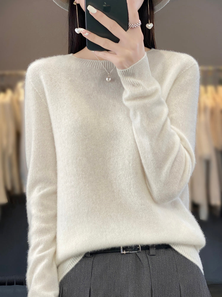 Soft knit pullover sweater in white with buttoned round neckline and long sleeves
