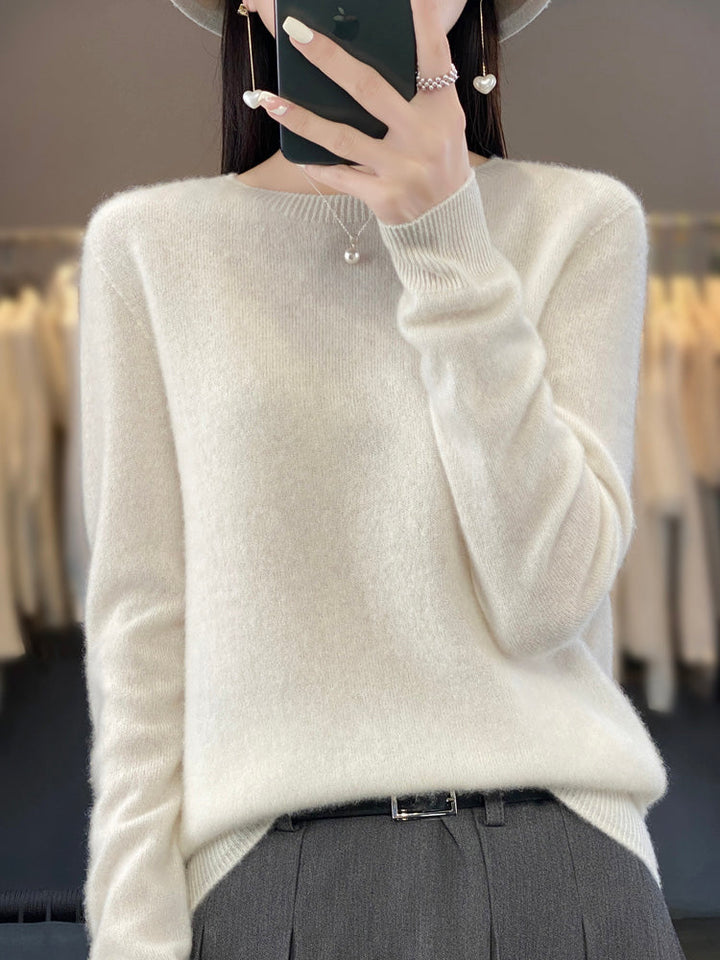 Soft knit pullover sweater in white with buttoned round neckline and long sleeves