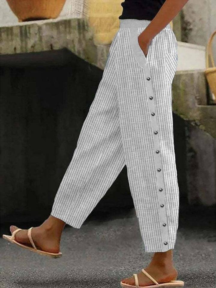 Light gray striped button-front pants with cuffed hems and center button placket