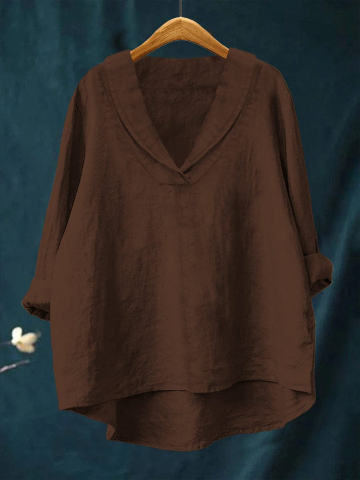 Brown relaxed linen blouse with V-neck and loose fit, long sleeves, draped hem.