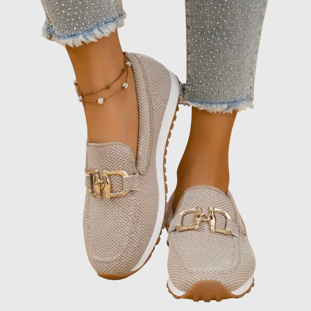 Beige chain-detail slip-on loafers with gold buckle hardware and textured upper