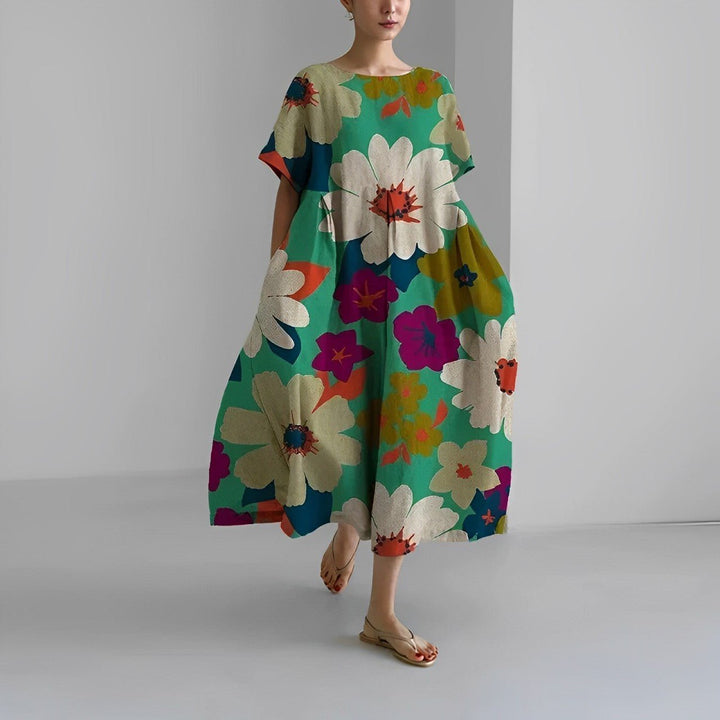 Floral flow midi dress in teal green with large cream flowers and colorful accents, loose.
