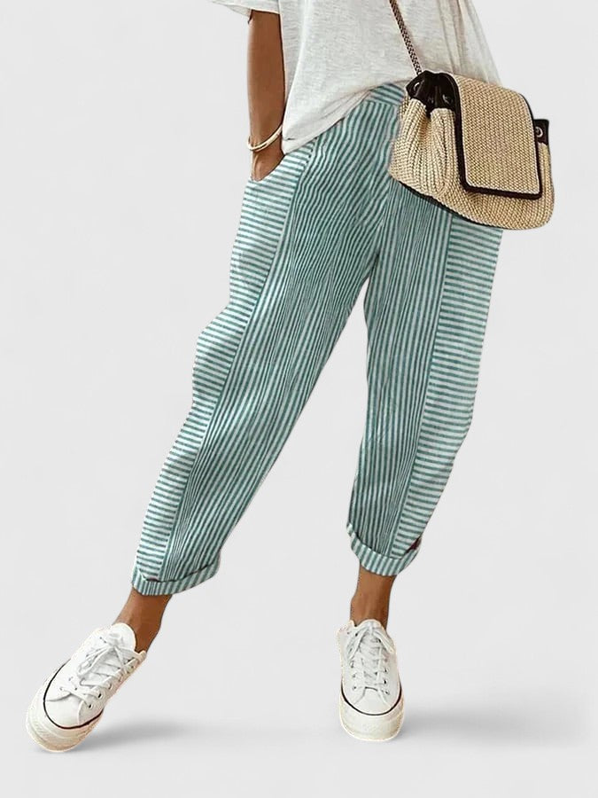 Green striped relaxed pants with elastic cuffs and pleated drape.